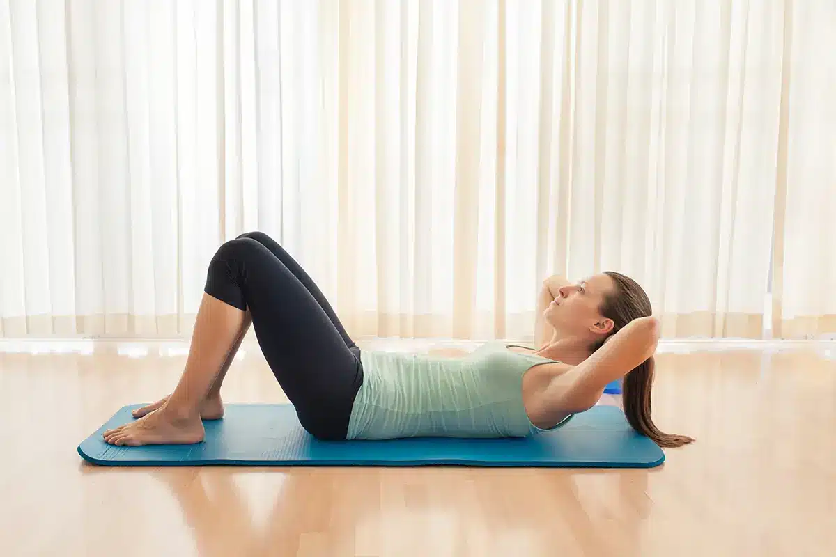 woman doing sit up exercise indoors